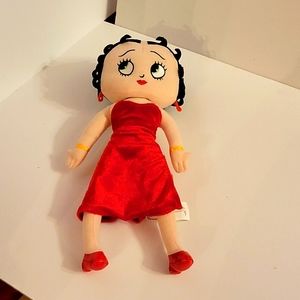 Betty Boop She has a nice red dress on andhas is wearing a heart on her leg.